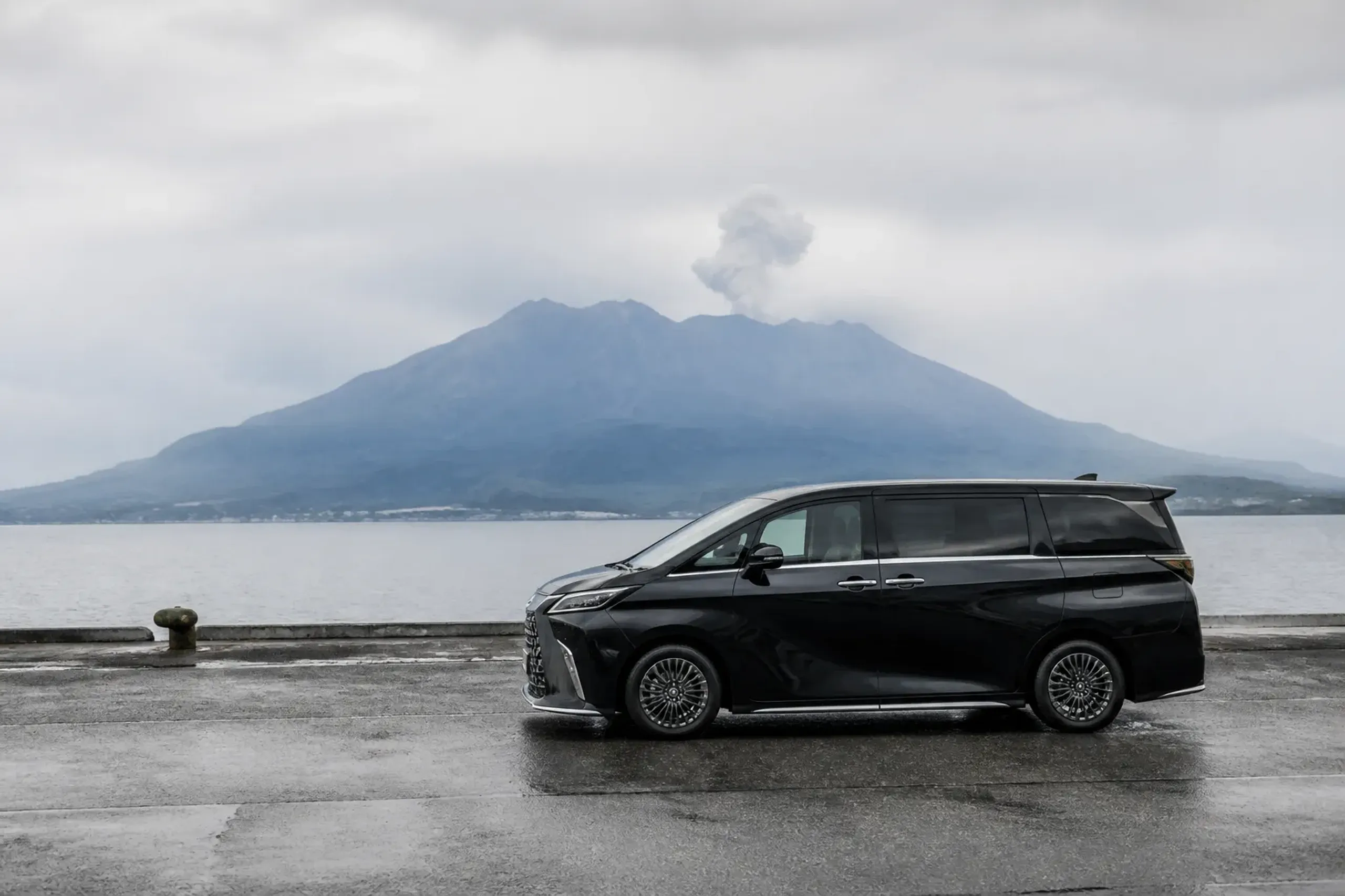 Lexus LM 500 private chauffeur vehicle waiting at Kagoshima cruise port with Sakurajima behind