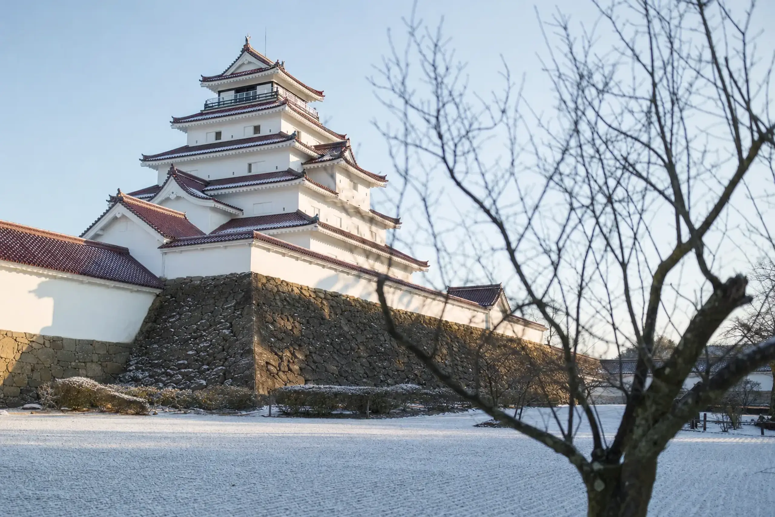 the five-storey keep of Tsuruga Castle in Aizu-Wakamatsu with its distinctive glazed red freeze-resistant roof tiles