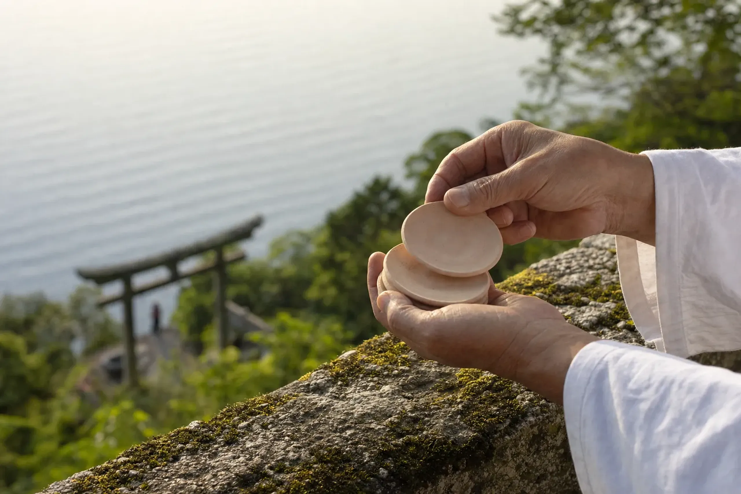 A stack of small unglazed clay kawarake discs held ready to be thrown from the Chikubushima overlook
