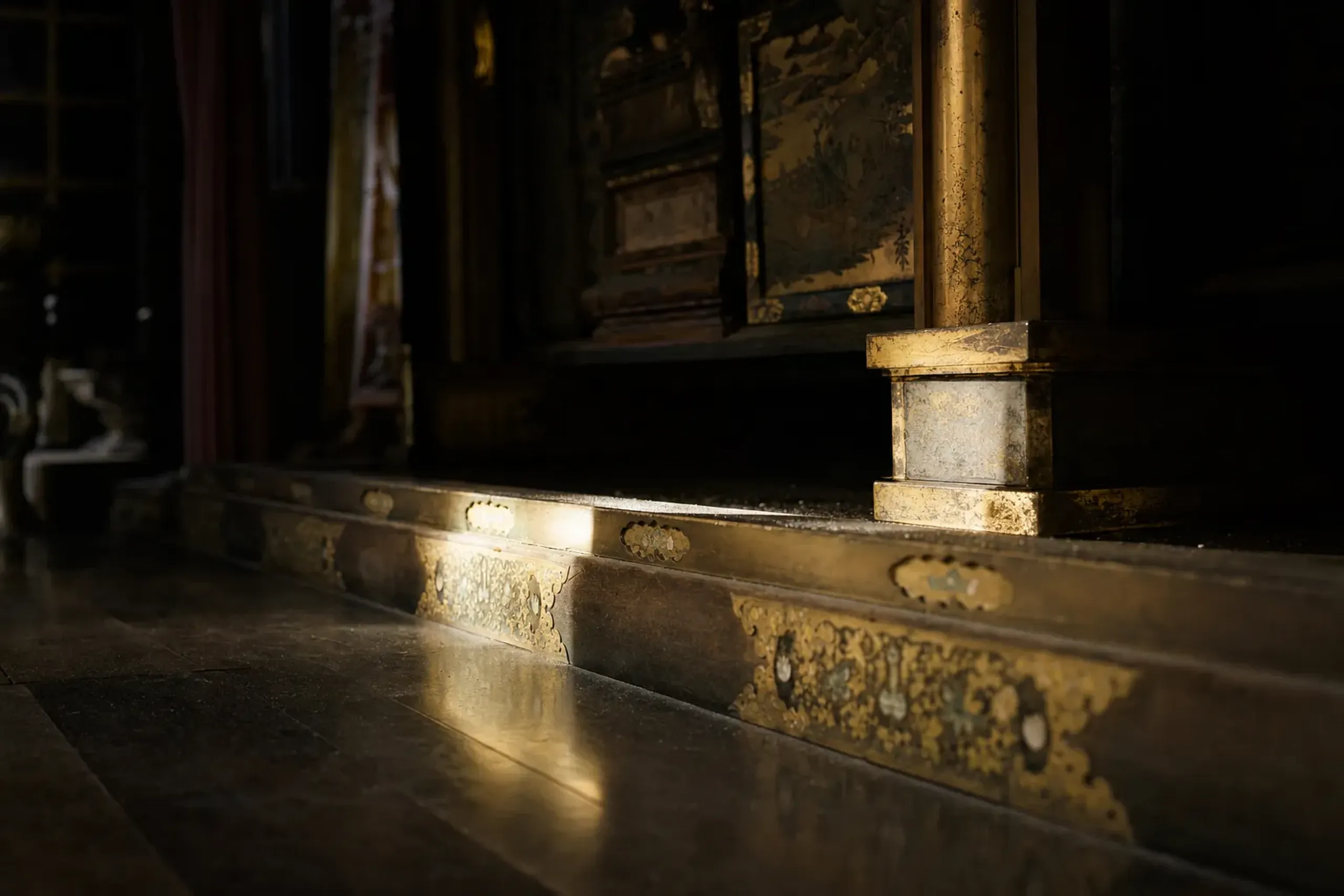 The interior mummified remains chamber beneath the central altar of the Golden Hall, sealed within the gilded platform structure