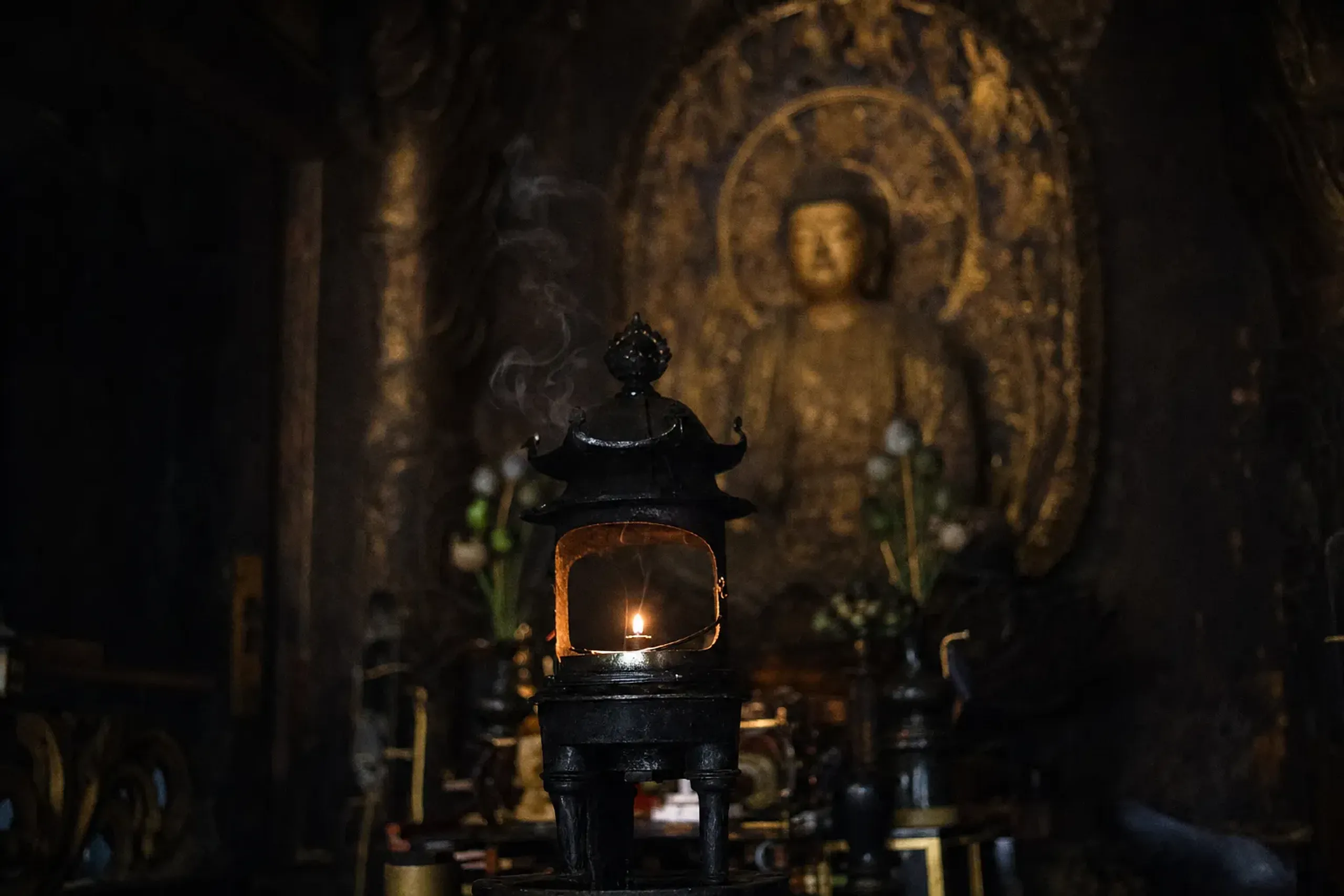 the Fumetsu no Hōtō eternal flame lantern burning at eye level before the Yakushi Nyorai image in the inner sanctum of Konpon Chūdō, Enryaku-ji