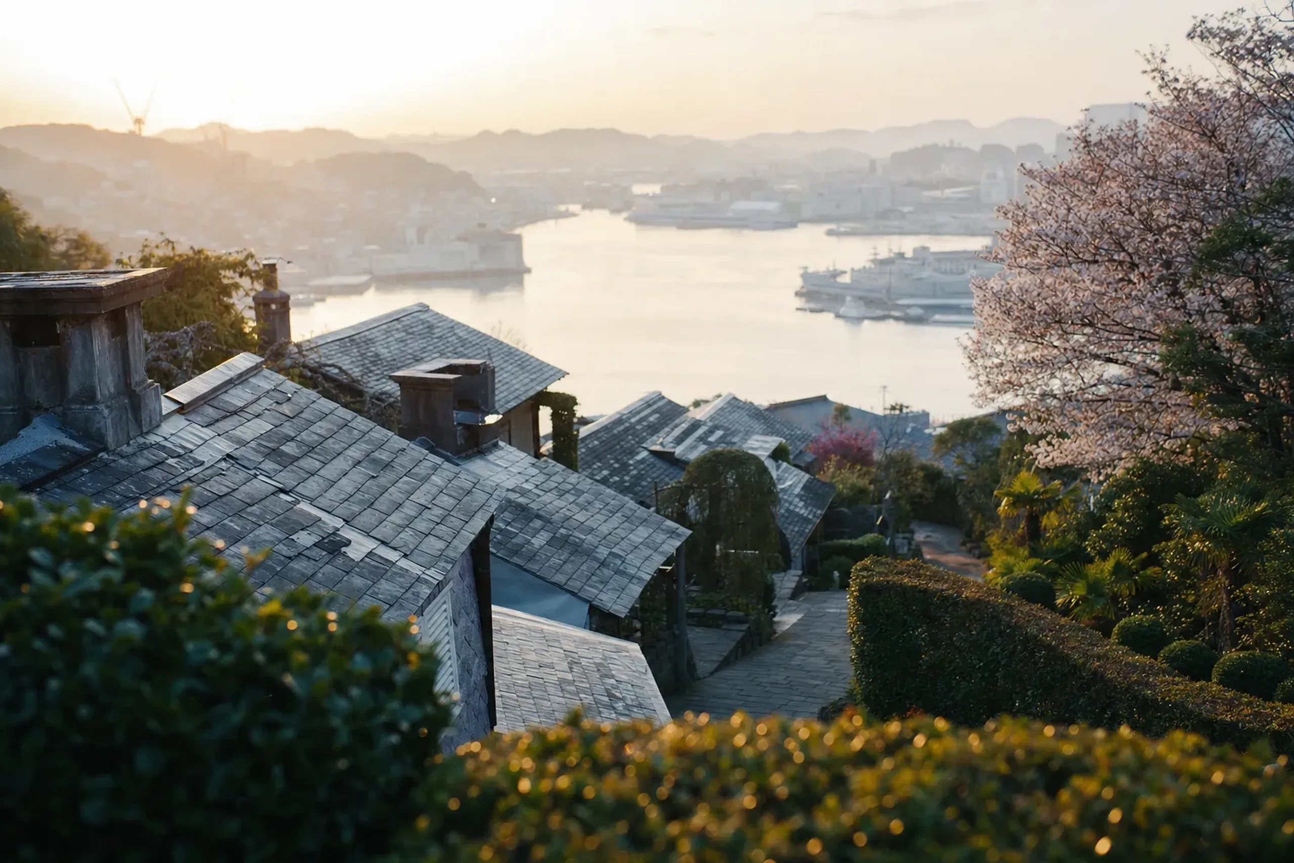 The tiered slate roofs of the Minami-Yamate district falling away in green terraces toward Nagasaki port