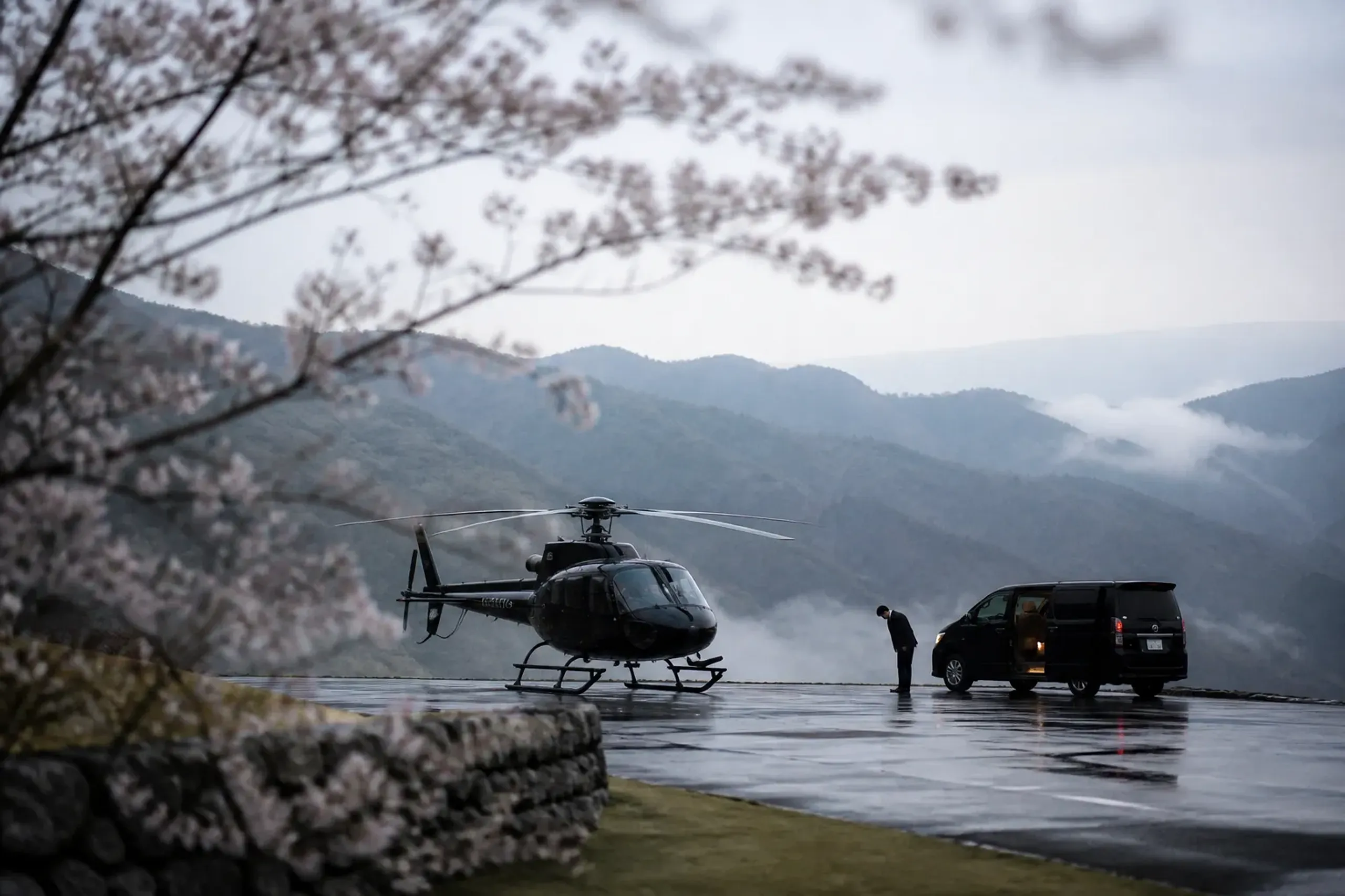 Private helicopter on a heliport with a waiting chauffeured car at dusk in the Japanese countryside
