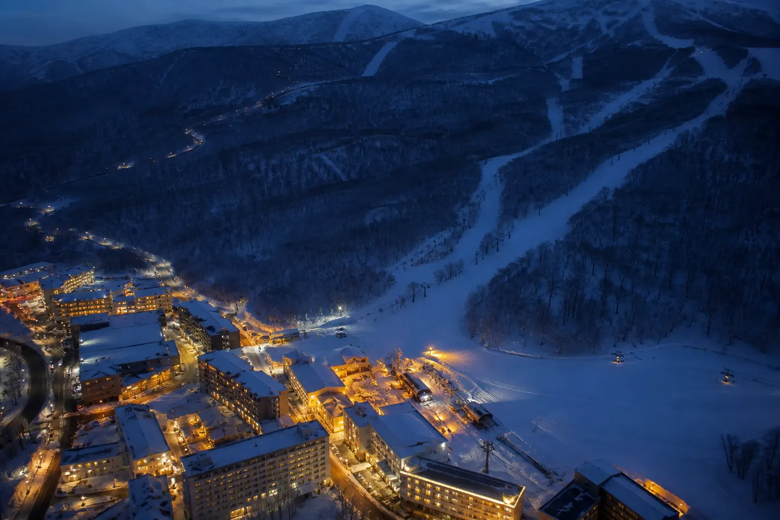 Snow-covered Hokkaido ski village at twilight