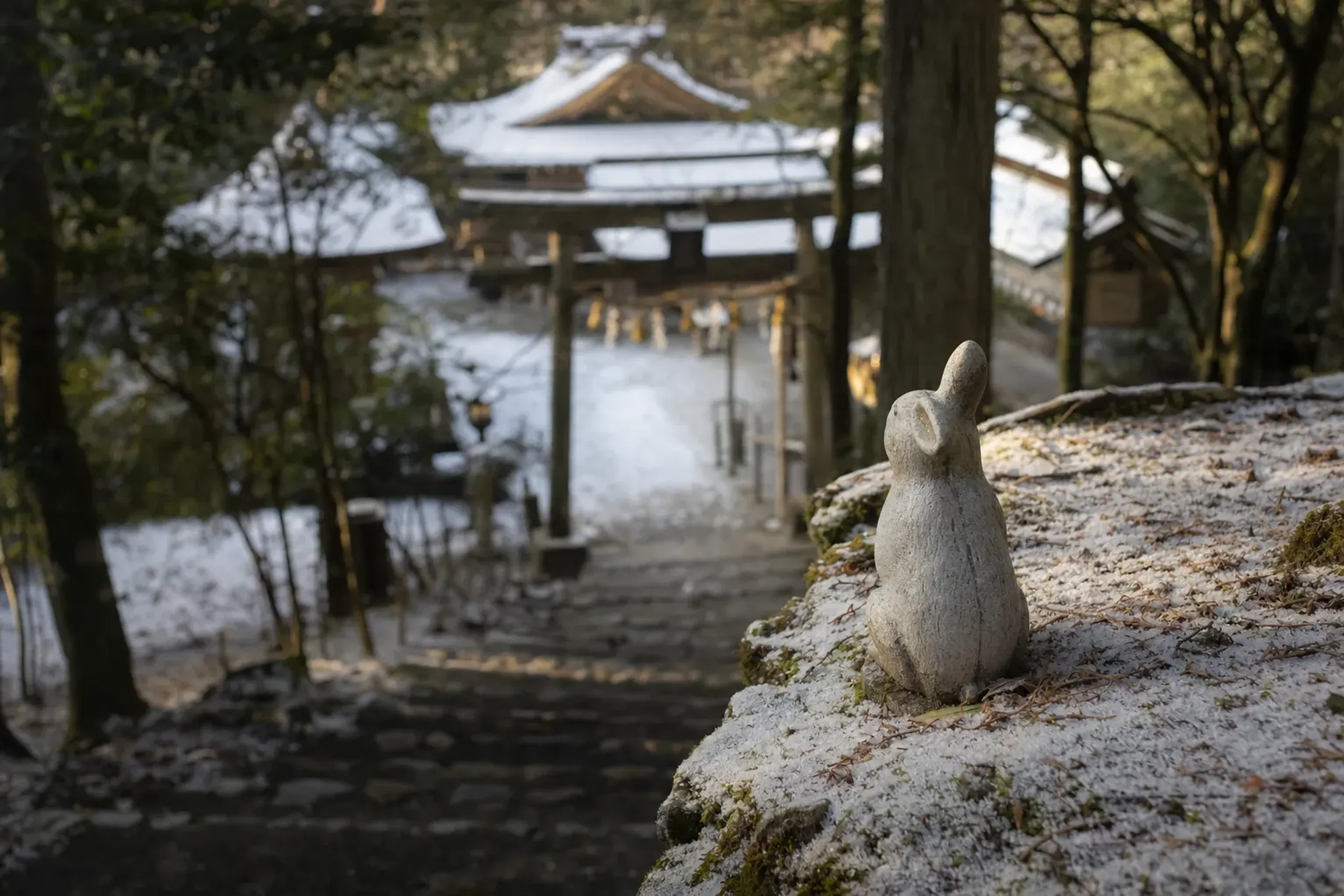 A small stone statue of a white rabbit on the approach grounds of Izumo Taisha