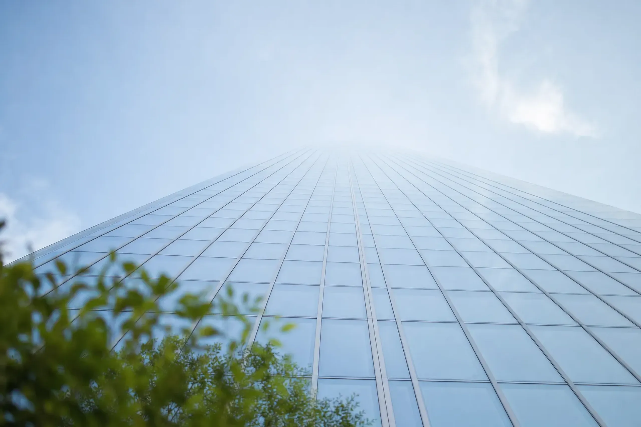 The clean vertical facade of Residence A tower at Azabudai Hills in Minato, rising against the Tokyo sky with light-handled glass surfaces