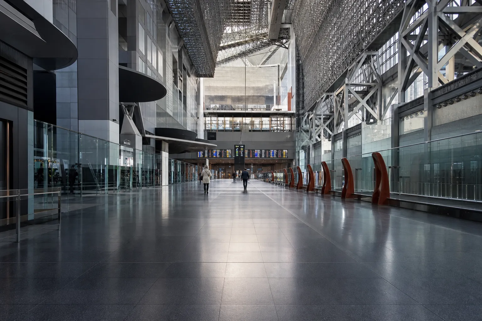 Quiet Kyoto Station corridor with departure boards visible in the distance