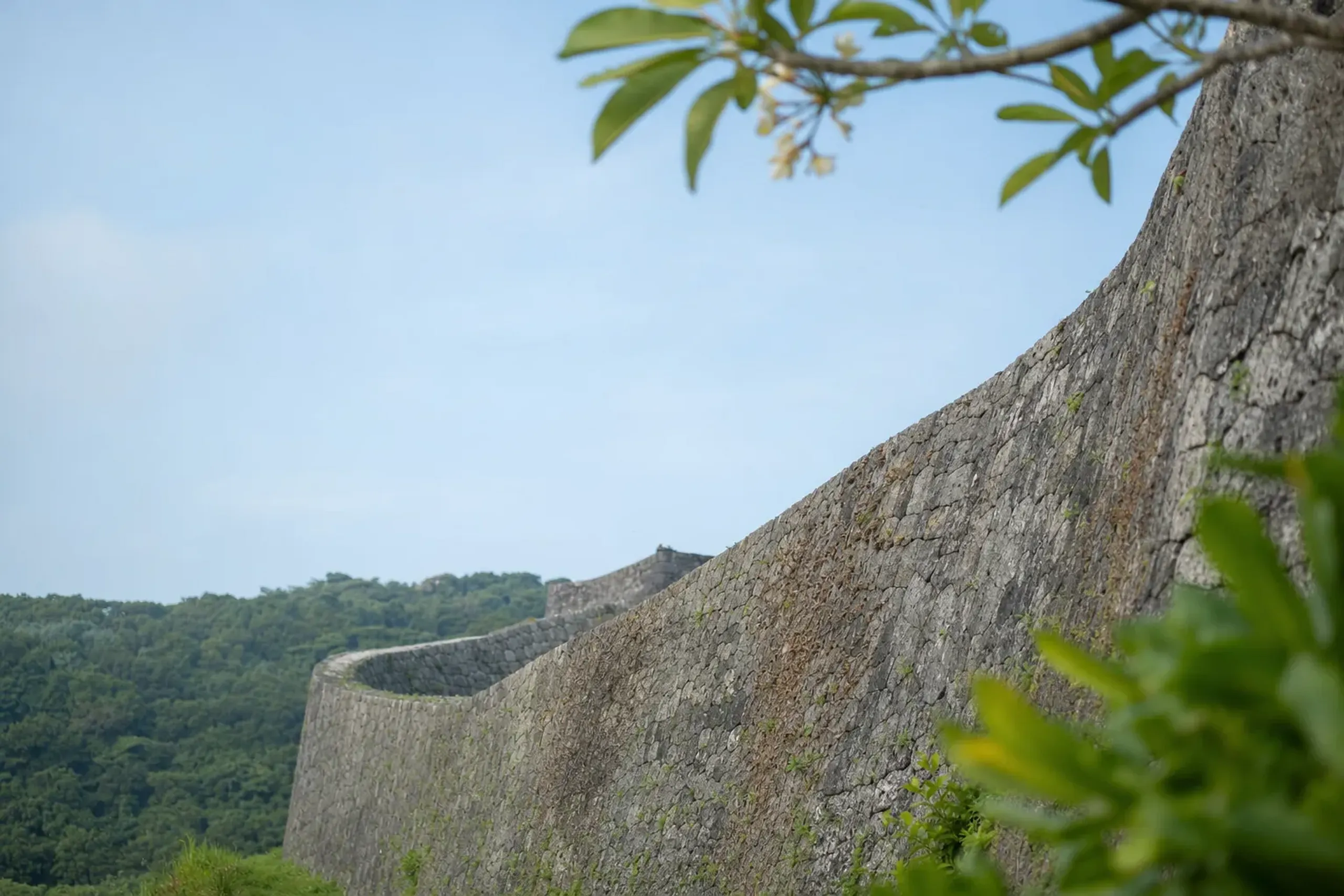 the stone ramparts and curved walls of Shuri Castle in Naha, former seat of the Ryukyu Kingdom