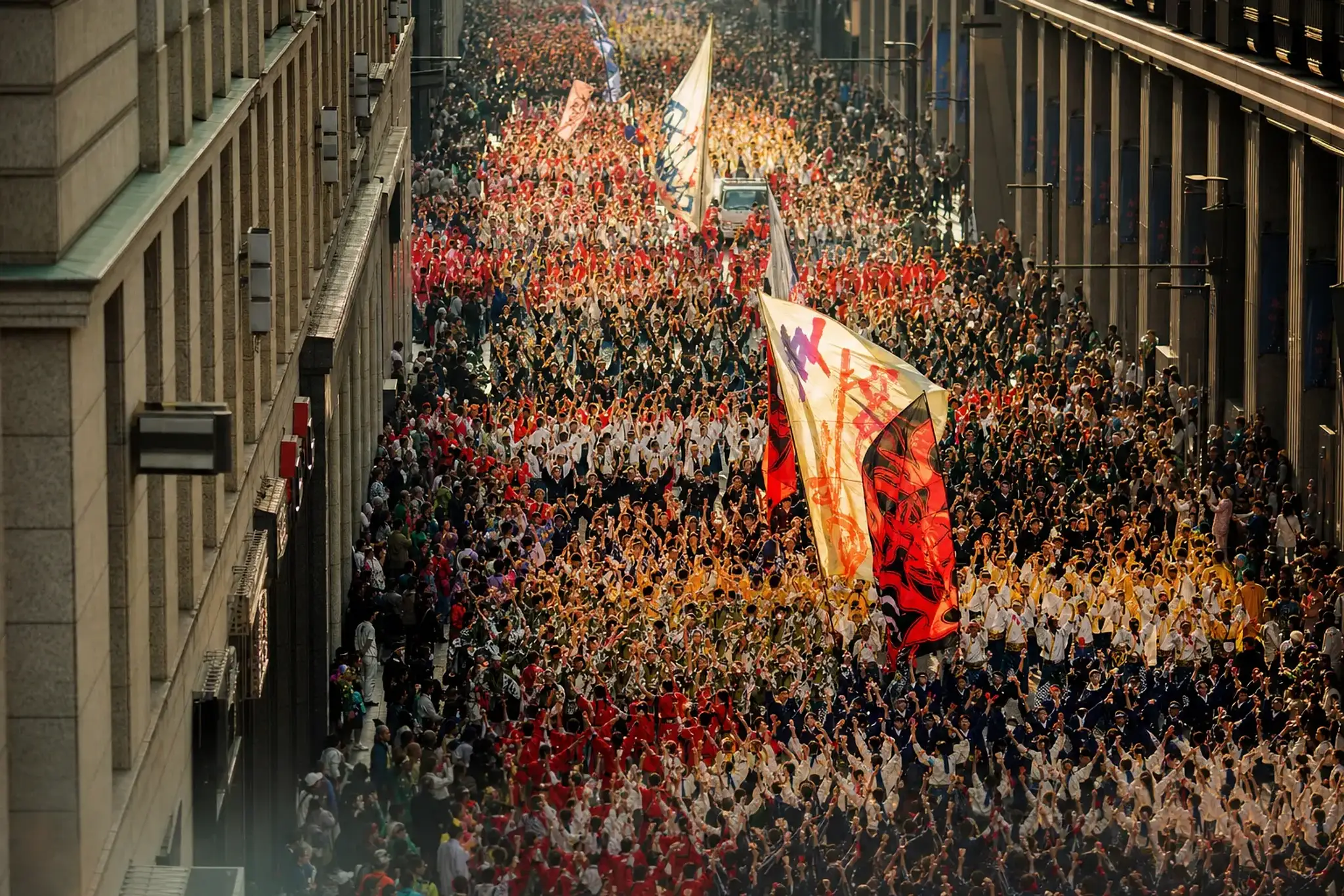 A vast crowd of costumed Yosakoi teams filling the length of Otesuji avenue in Kōchi during the festival