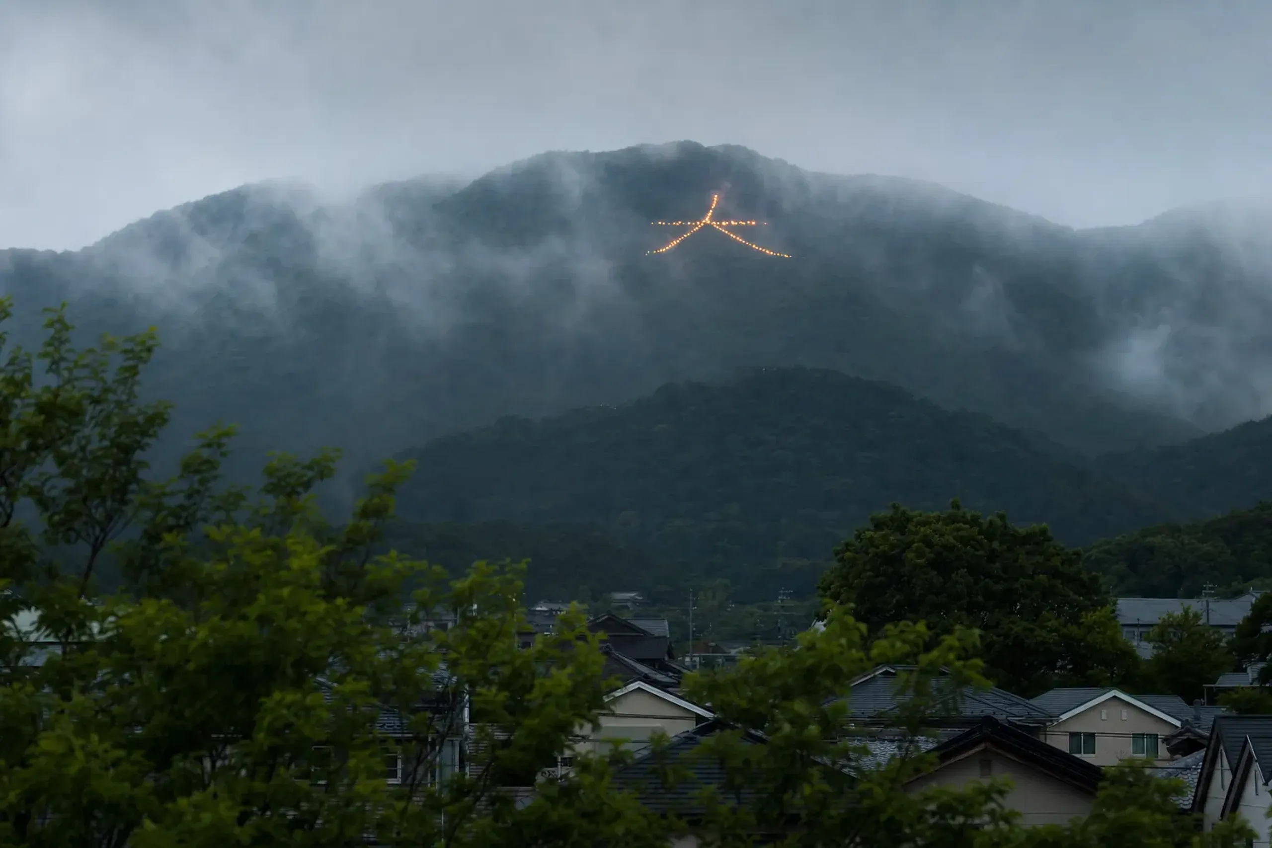 The Hidari Daimonji (左大文字) reversed character bonfire burning on Daihokusan mountain in Kyoto