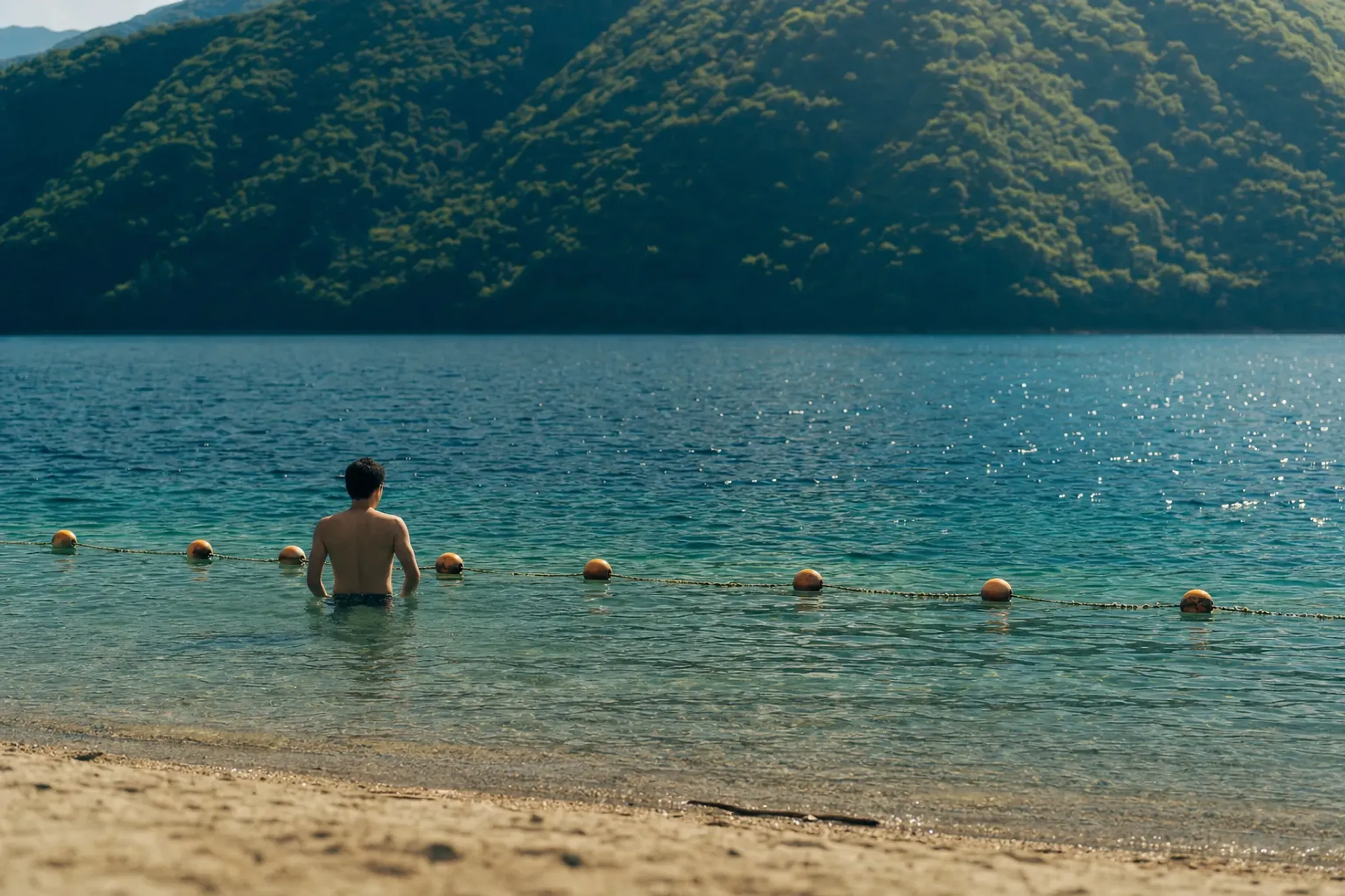 Yes — swimming is permitted only in the designated, rope-mar