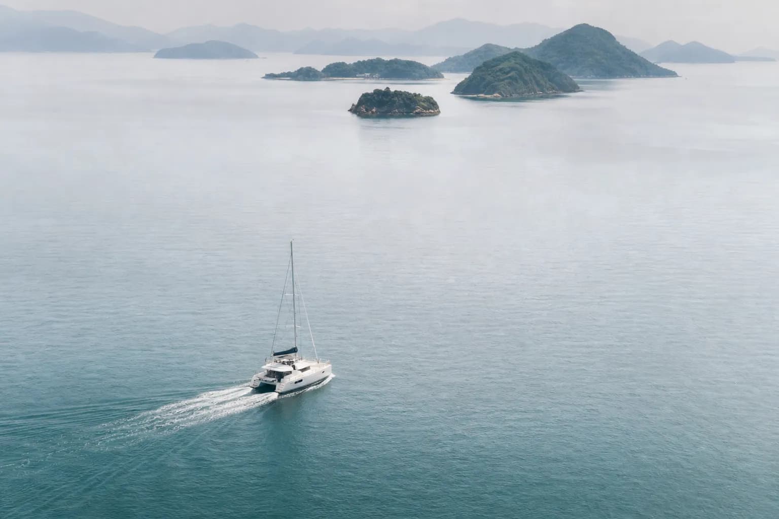 Private yacht cruising in the Seto Inland Sea with islands in the background