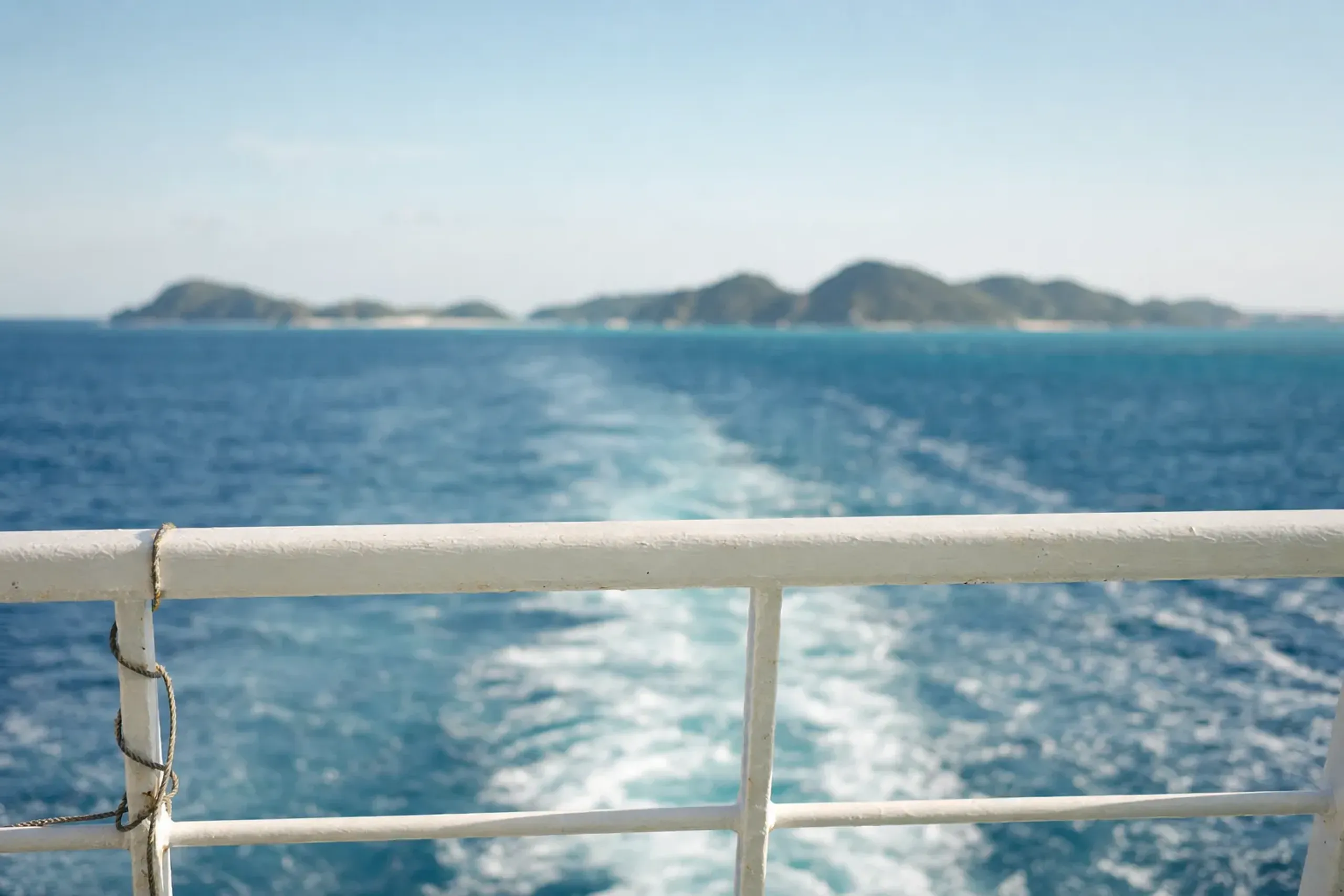Passenger ferry crossing clear water toward the Kerama Islands from Okinawa main island