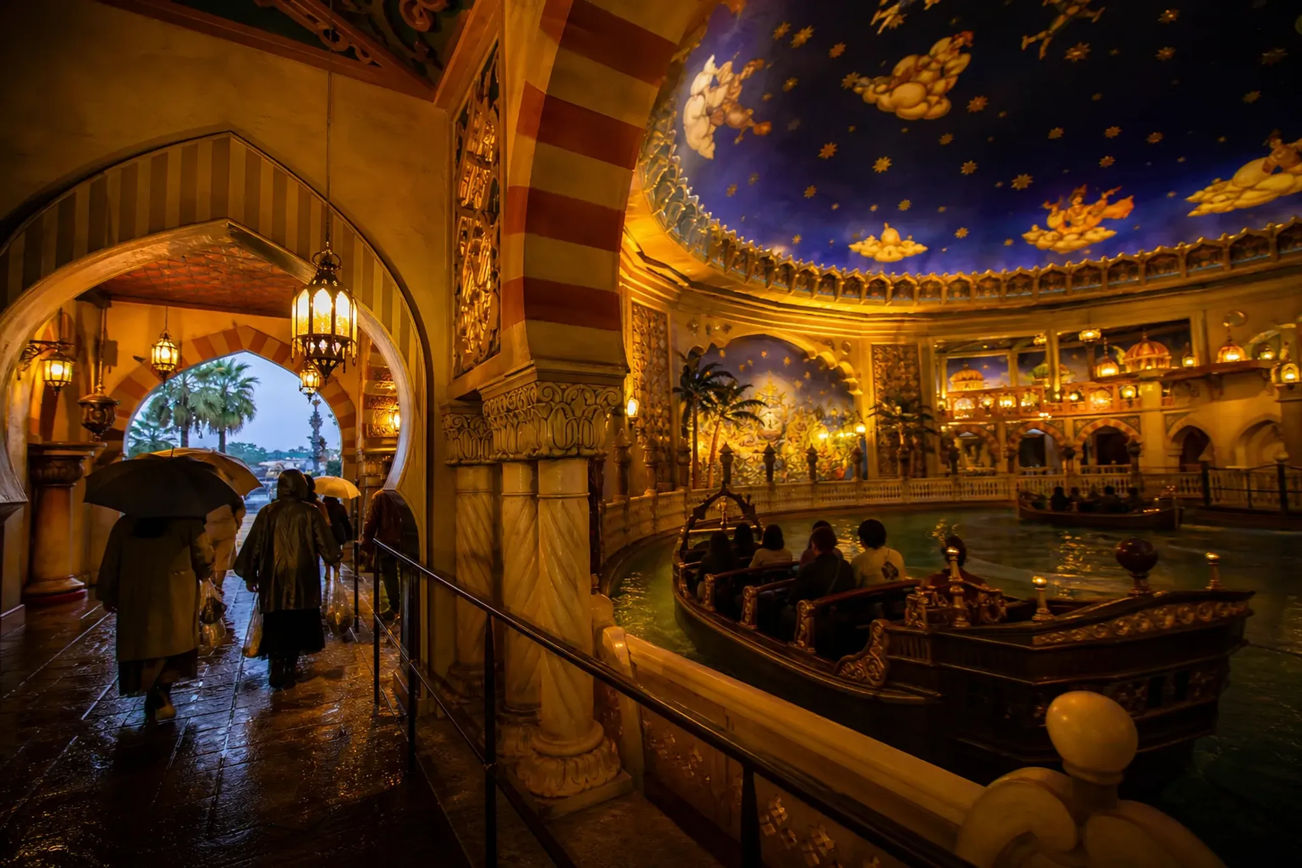 the illuminated indoor domed interior of the Sinbad's Storybook Voyage attraction building at Tokyo DisneySea, sheltered from rain