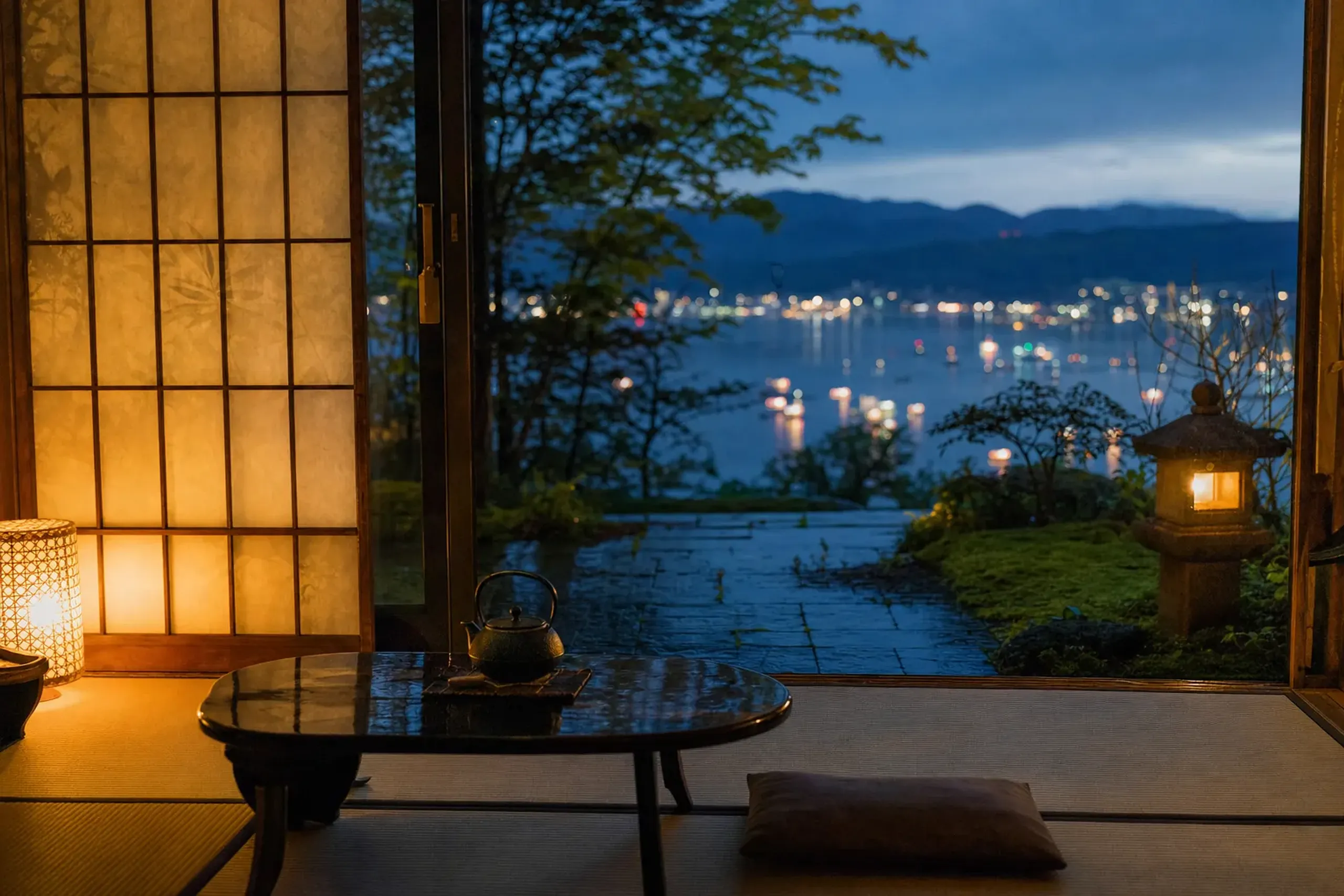 A traditional ryokan room in Kamisuwa Onsen with a view over Lake Suwa in the early evening