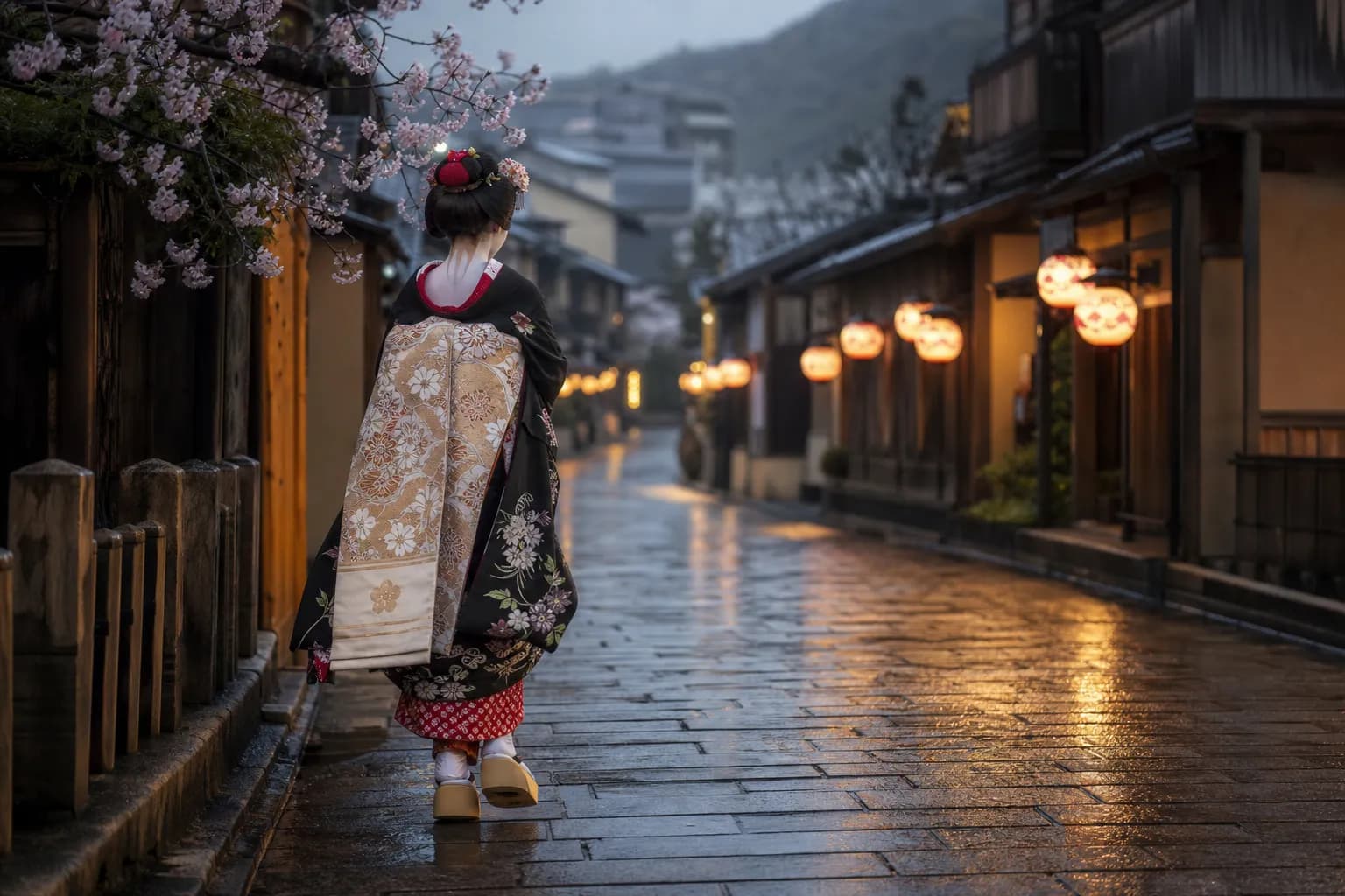A maiko in white makeup and layered kimono walking purposefully through a lantern-lit stone lane in Southern Gion, Kyoto, at dusk, moving between appointments