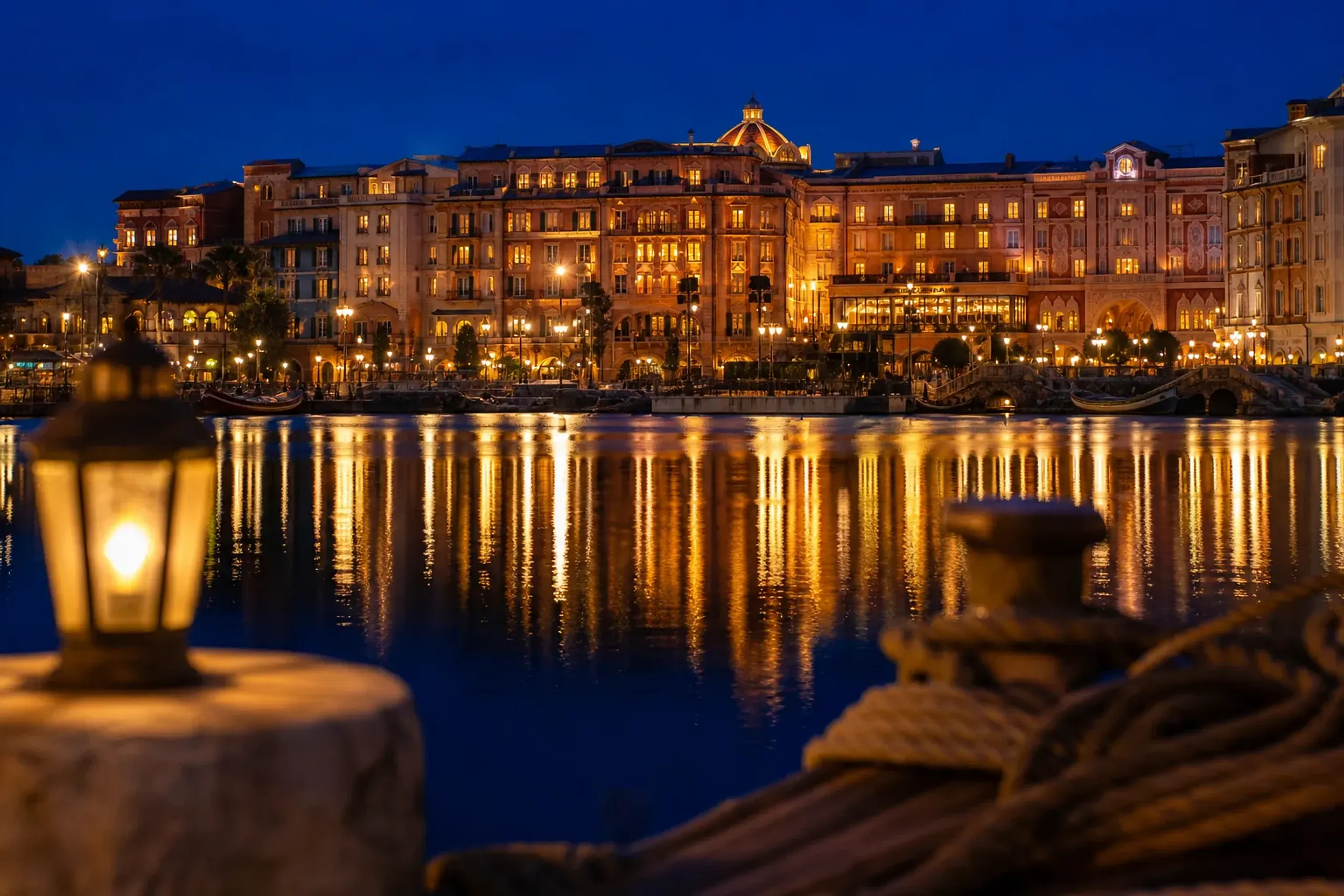 Tokyo DisneySea Hotel MiraCosta exterior at night with lights reflecting on the water