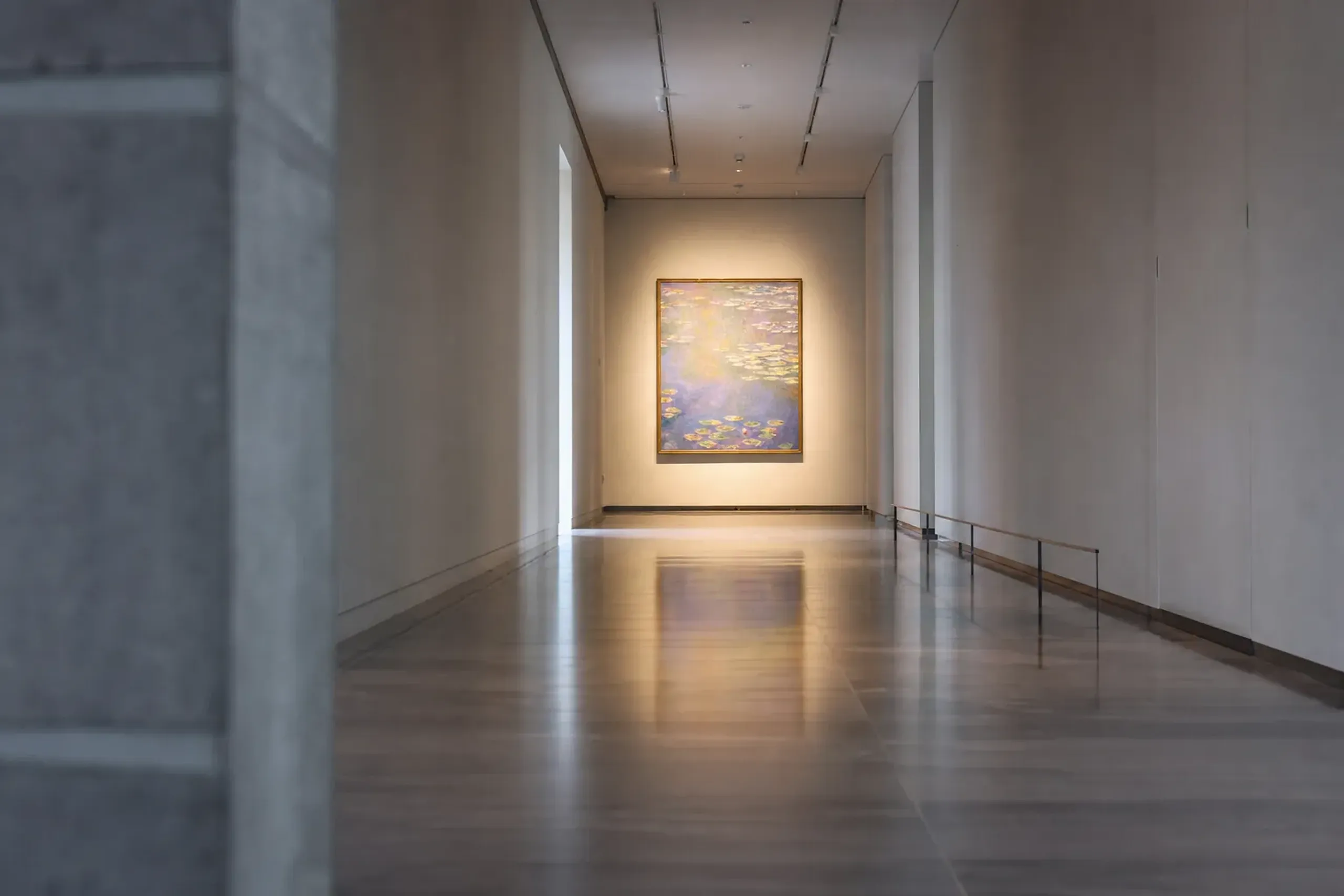 A quiet, empty gallery loop inside the National Museum of Western Art with a single Impressionist painting on a far wall