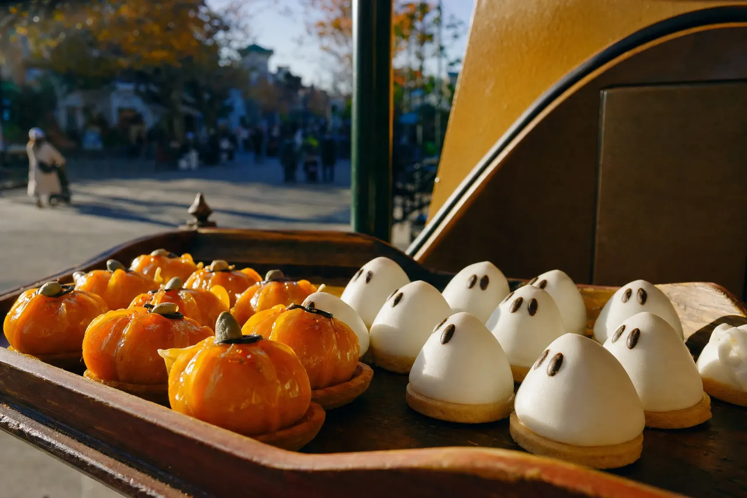 Seasonal autumn Halloween-themed sweets and pumpkin-shaped snacks displayed at a Universal Studios Japan food cart