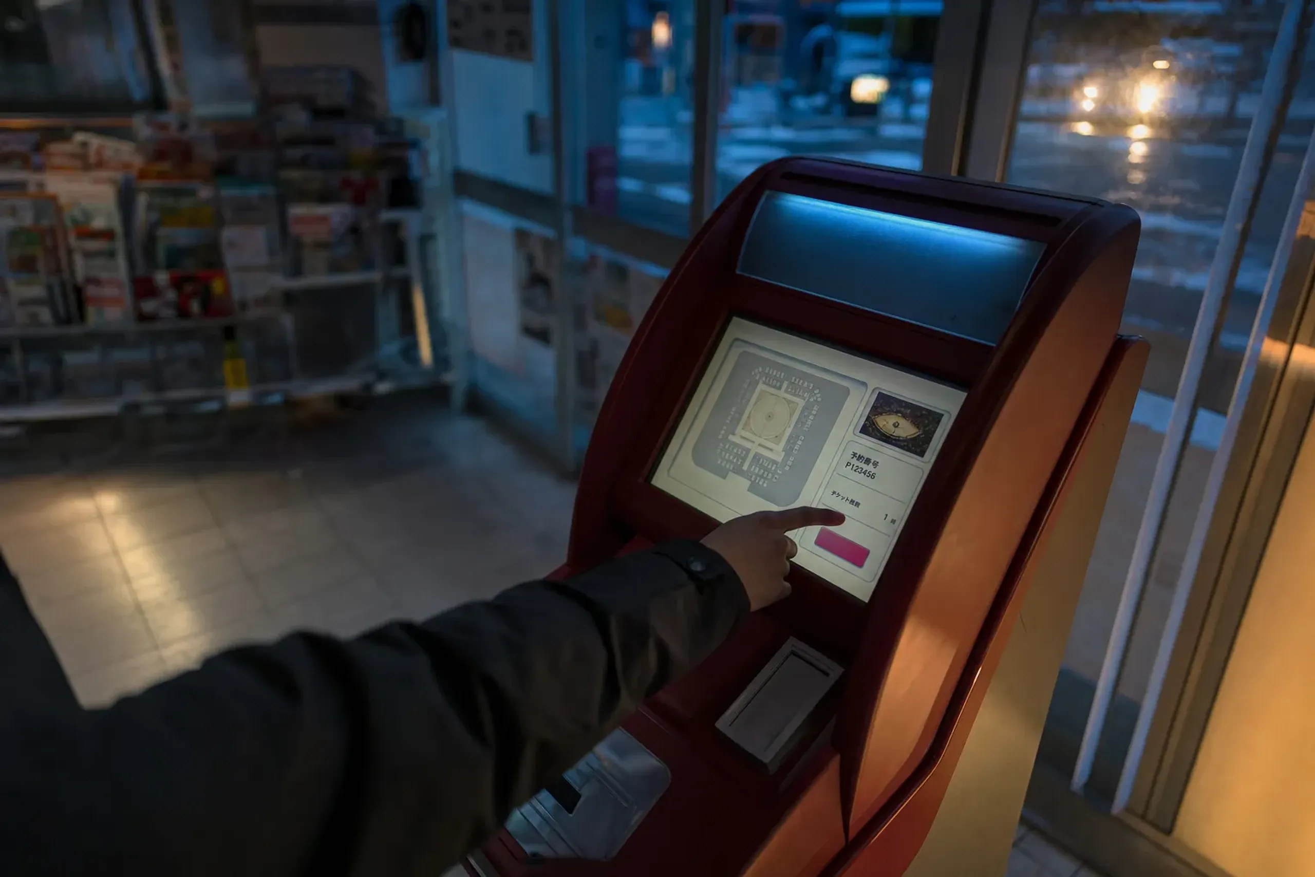 A convenience-store ticket terminal in Tokyo displaying the ticket purchase interface