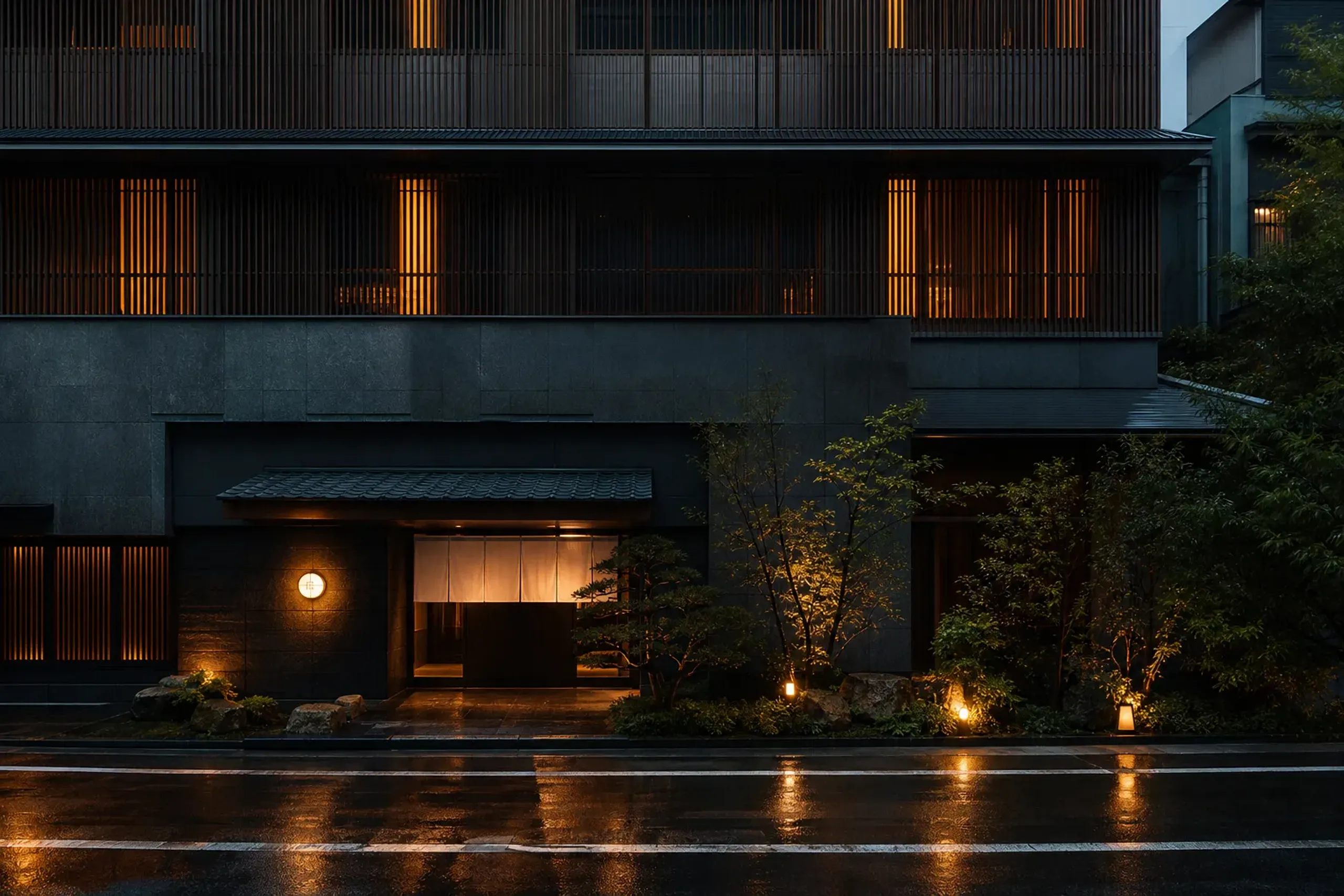 Contemporary luxury hotel exterior in Osaka at night with understated lighting