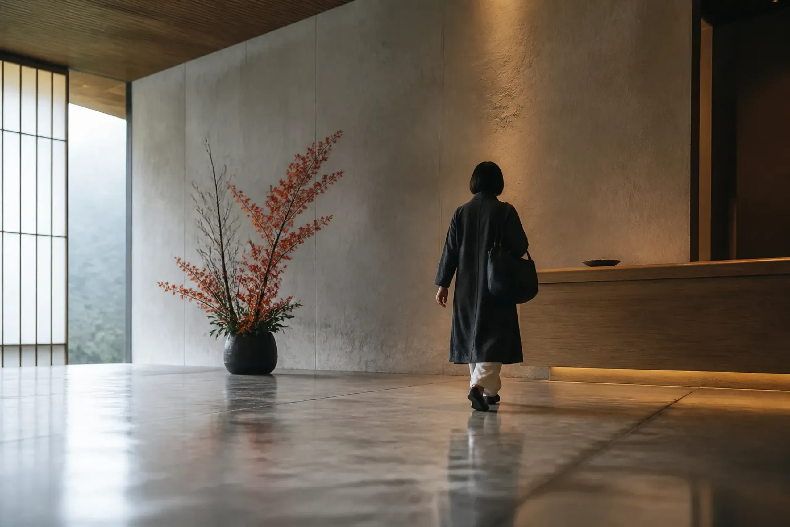 Guest checking into a Japanese hotel lobby carrying only a small bag