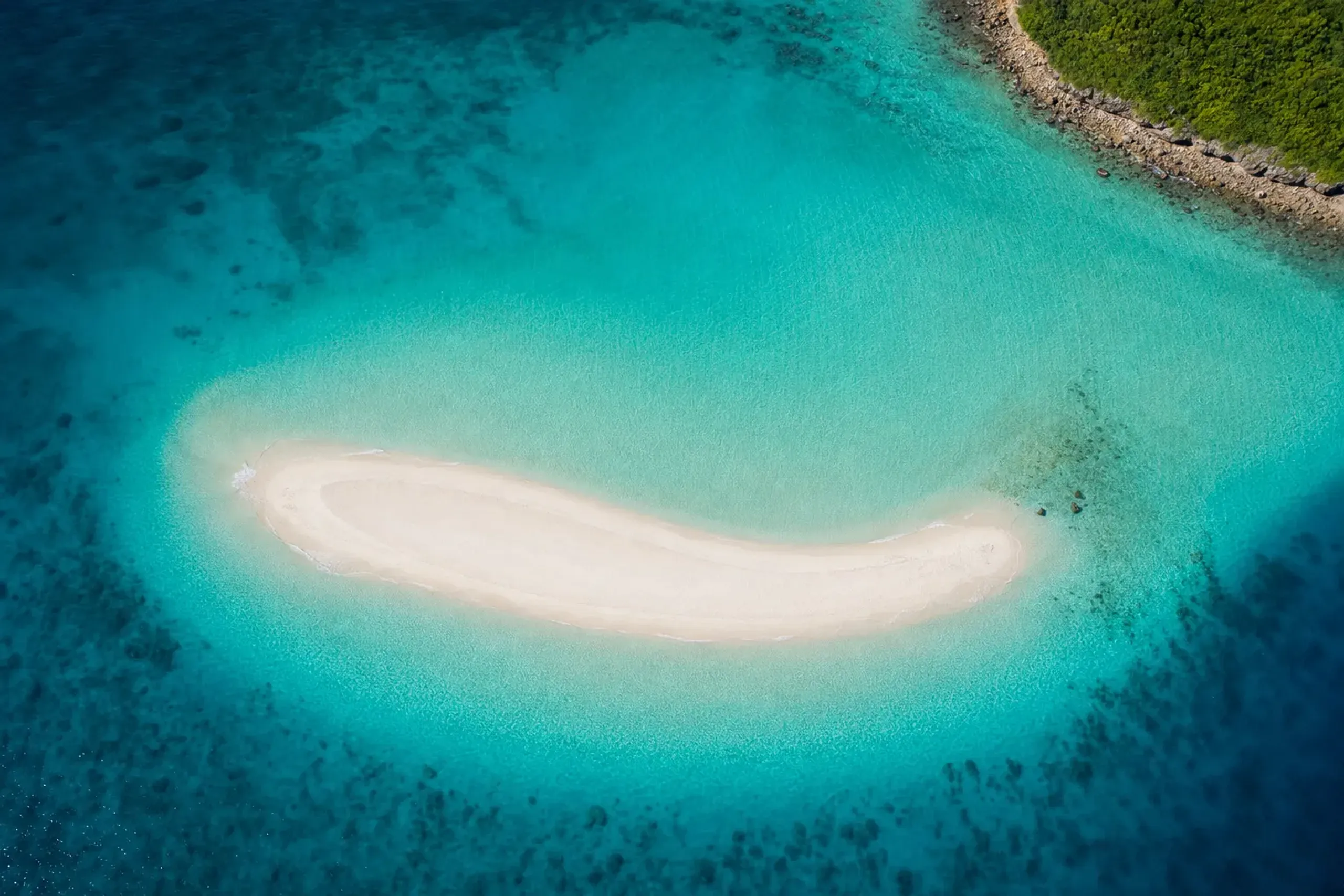 Aerial view of Yurigahama white sandbar surrounded by turquoise water off Yoron Island