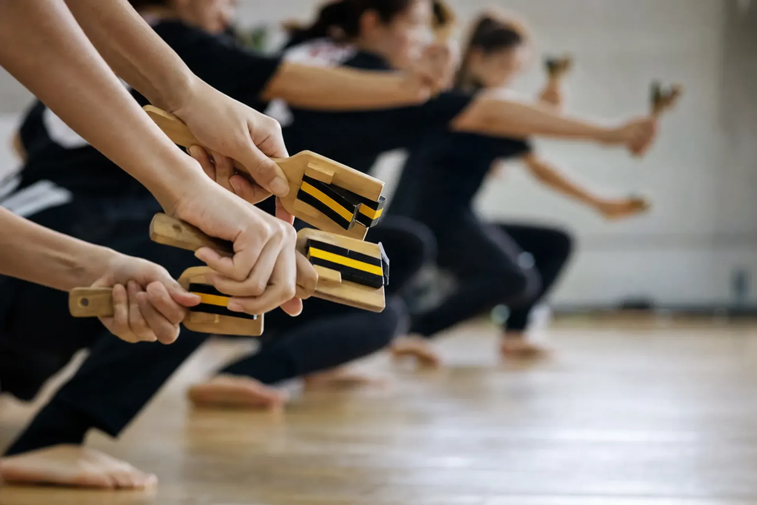 Young dancers rehearsing with naruko clappers in Sapporo, echoing the festival’s 1992 student origins