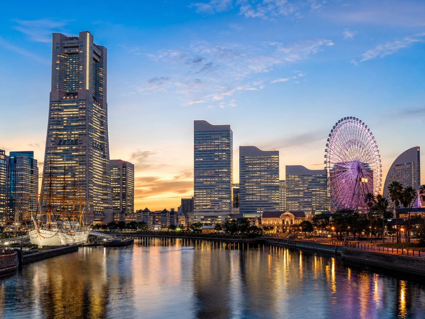Minato Mirai skyline glowing over Yokohama bay at dusk