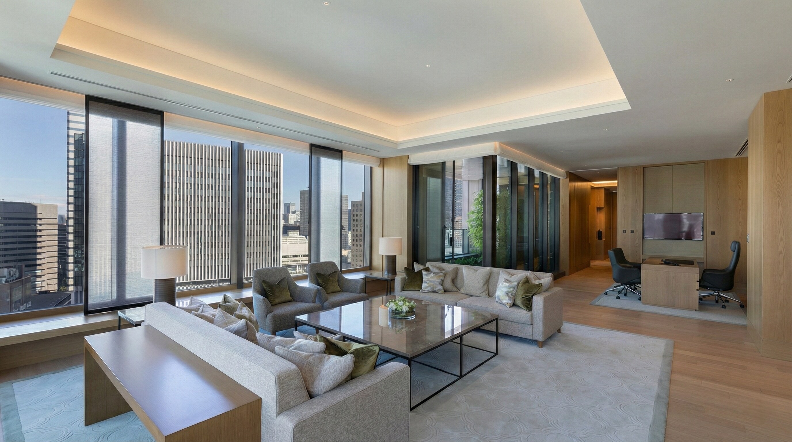 The spacious living room of the Okura Presidential Suite opens out onto a private garden balcony.