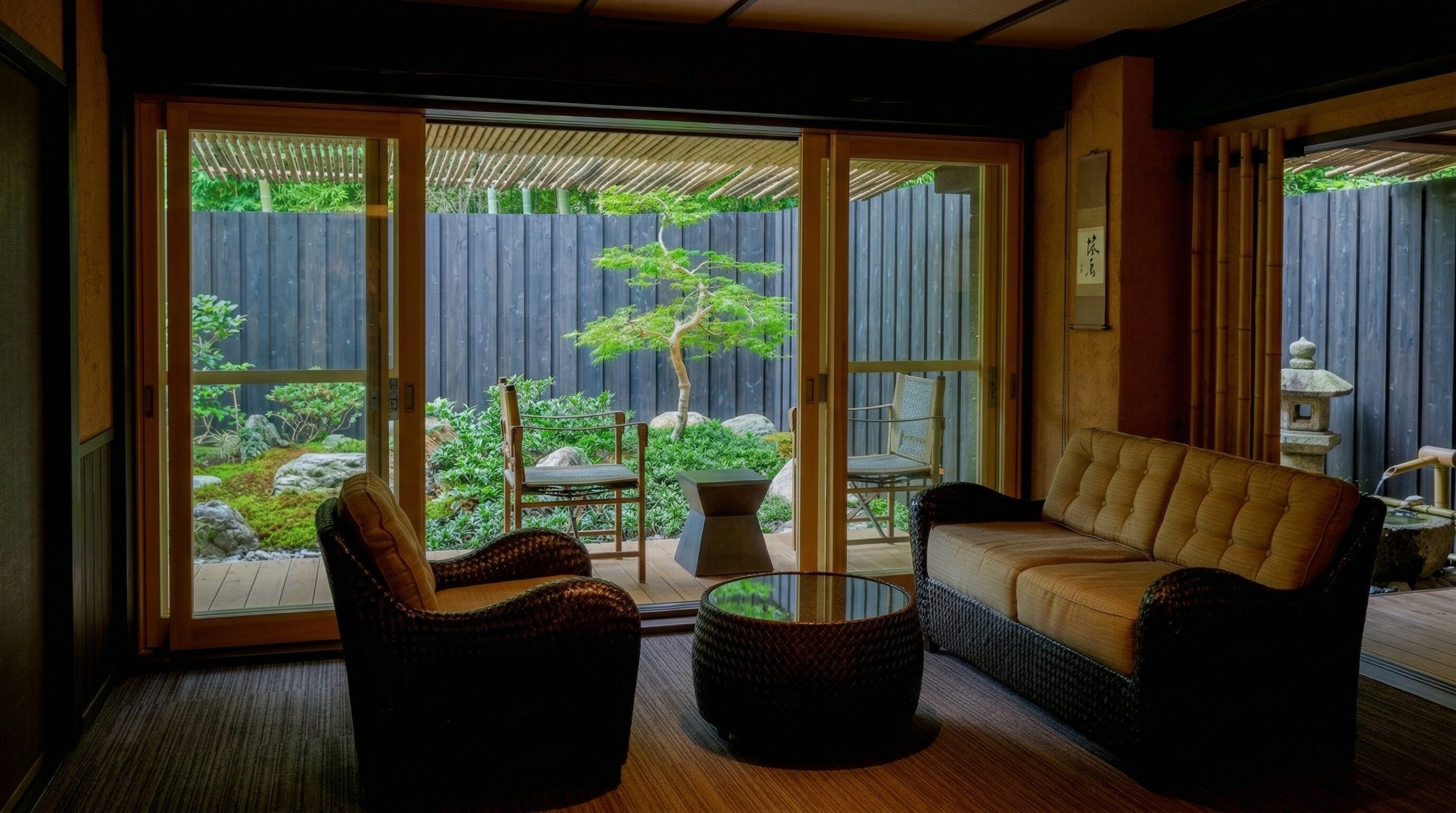 The spacious living room of the Mikado Suite features tatami mats, modern sofas, and large windows.