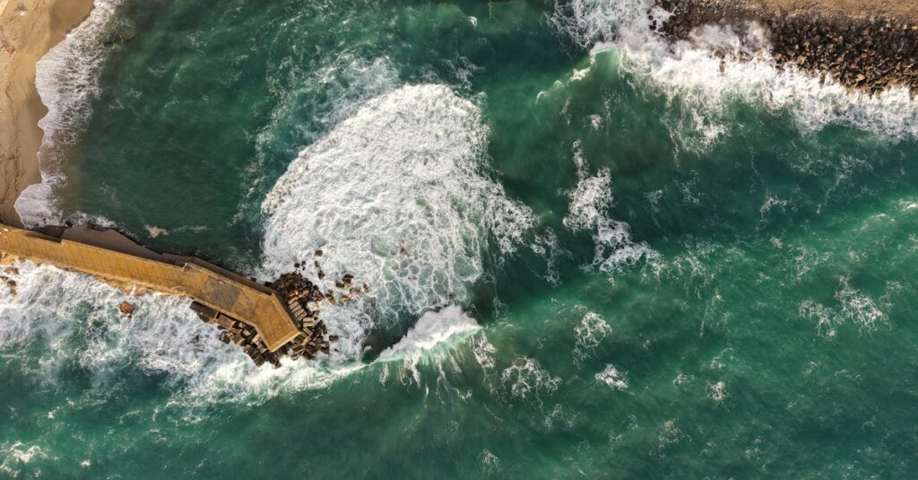 Aerial shot of Pizzo's coastline capturing vibrant waves and scenic sea views. — Photo by Wal Vas on Pexels