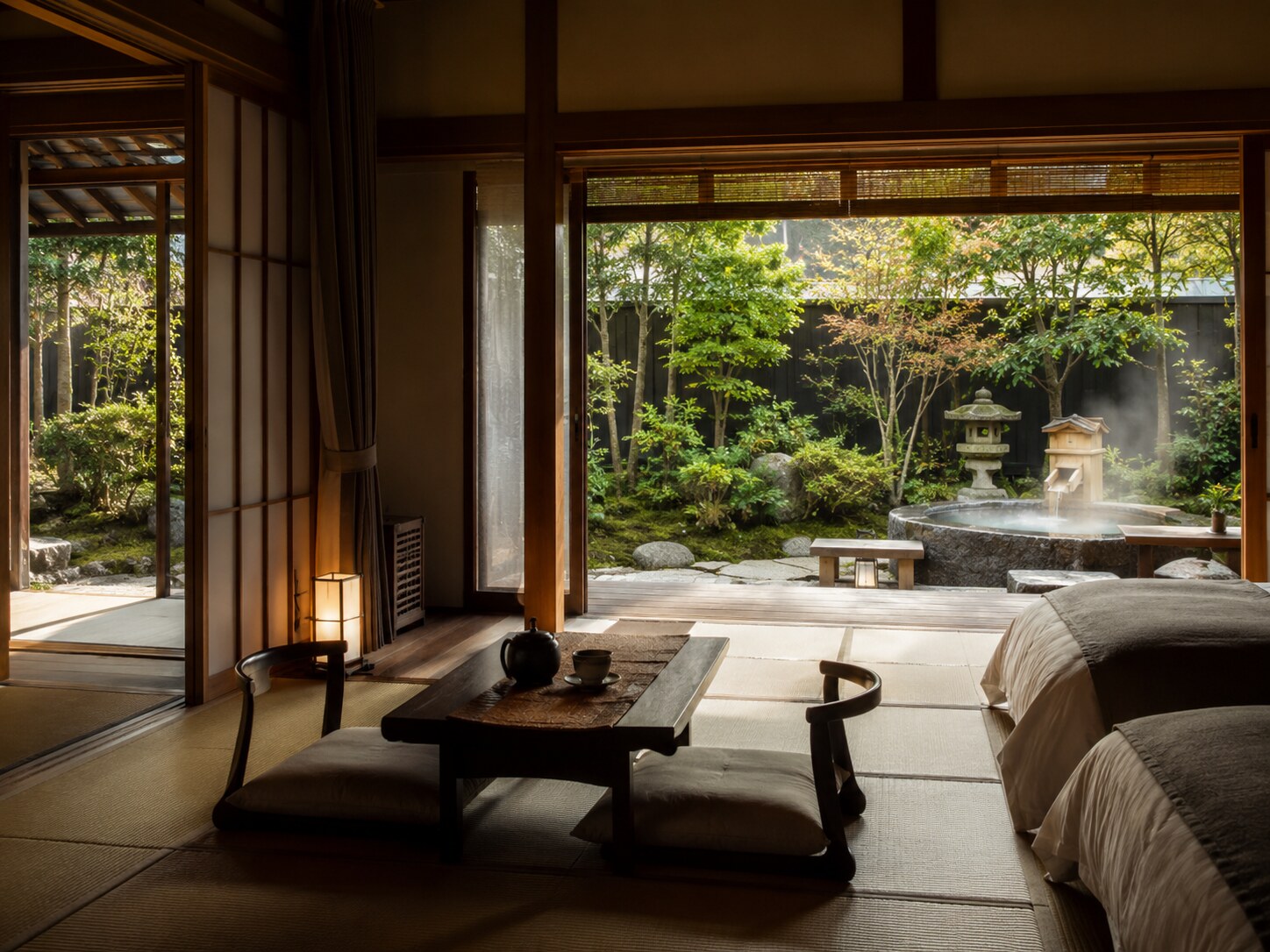 Japanese-style room with tatami floor, low table and floor cushions; opens to a garden with a stone lantern and steaming water basin.