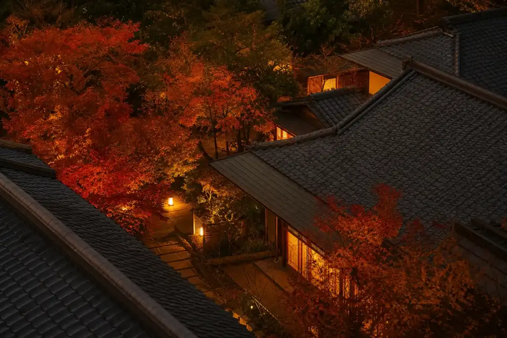 Night view of traditional tiled rooftops with orange autumn trees and warm lantern lights