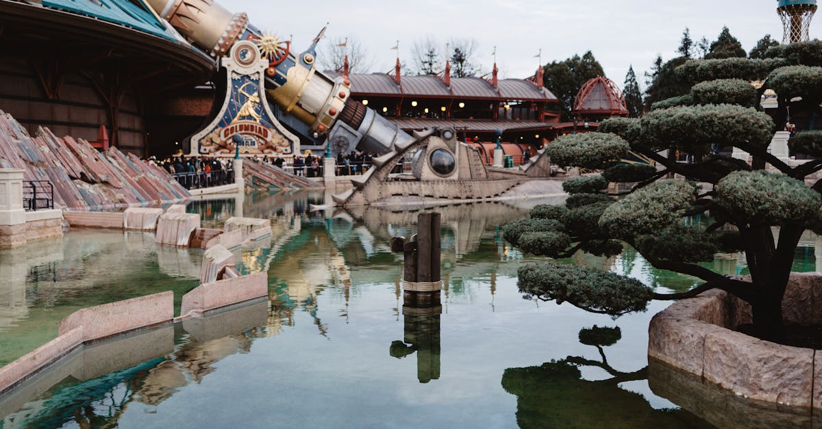 Reflective pond with a futuristic attraction at a theme park in Coupvray, France. — Photo by Sebastian Luna on Pexels