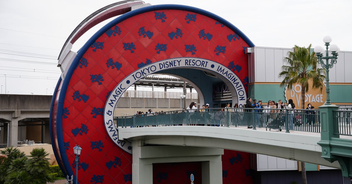 Capture of the Tokyo Disney Resort entrance featuring the Bon Voyage Store and pedestrian bridge. — Photo by Dmitry Romanoff on Pexels