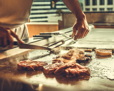 Close up hands chef cooking beef steak and vegetable on hot pan, Japanese food
