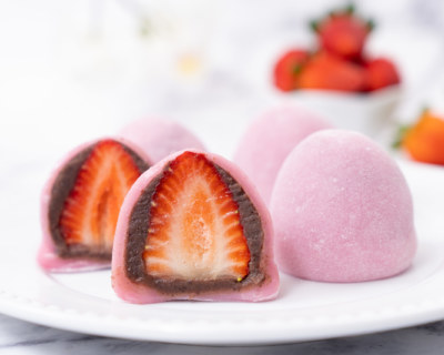 Japanese confectionery Ichigo Daifuku, small round glutinous rice dessert with fresh strawberry and red bean paste